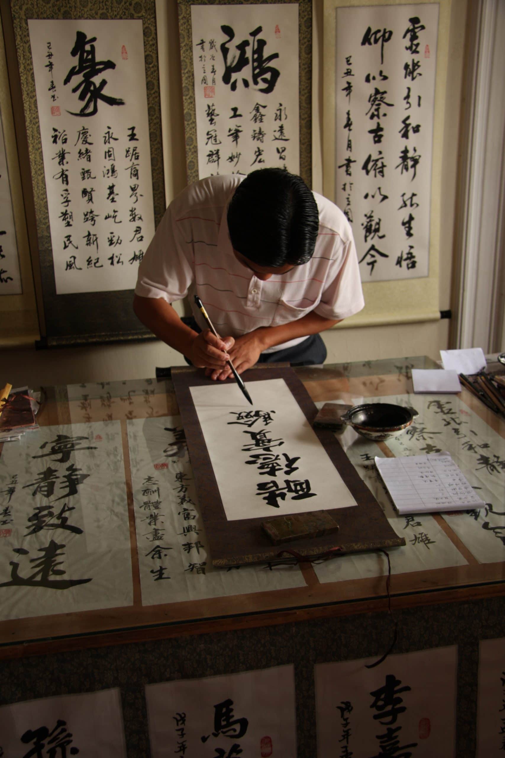 Calligrapher writing with a dip pen - calligraphy vs hand lettering